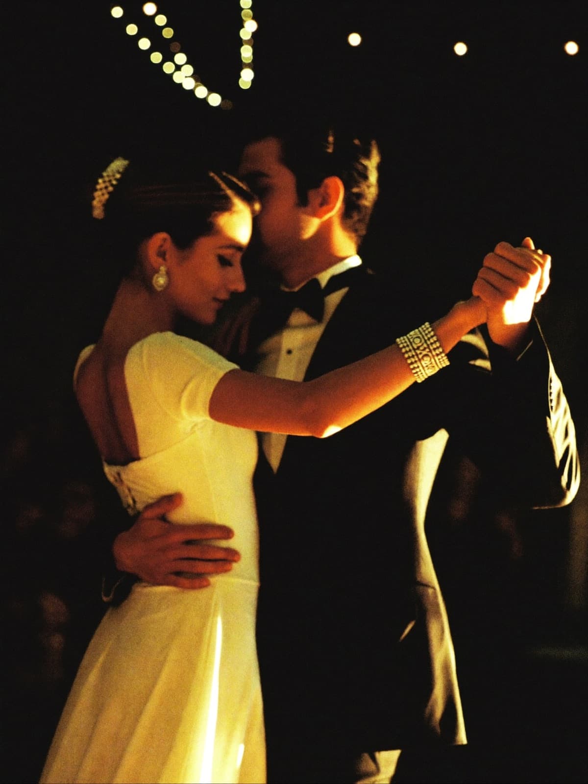 A couple dancing bachata in warm light